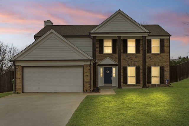 view of front of house with brick siding, a lawn, concrete driveway, and a garage