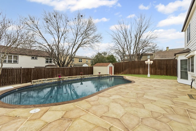 view of pool featuring a shed and a patio