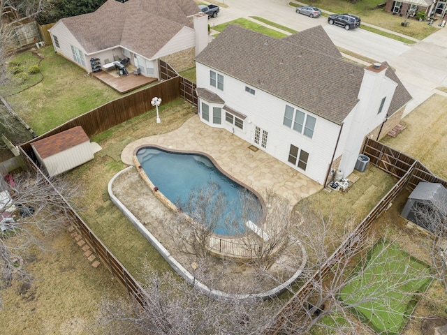 view of swimming pool with a shed and cooling unit