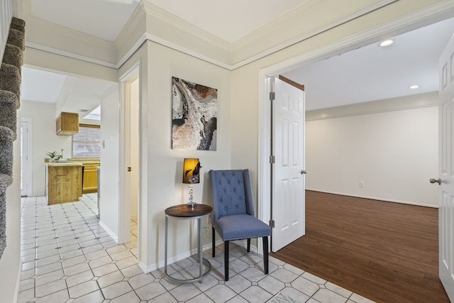 sitting room with ornamental molding and light hardwood / wood-style floors