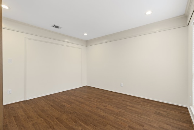 empty room with crown molding and dark hardwood / wood-style floors