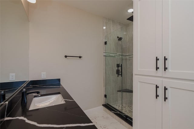 bathroom with sink and a shower with shower door