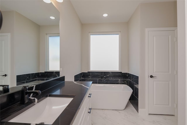 bathroom with vanity and a bathtub