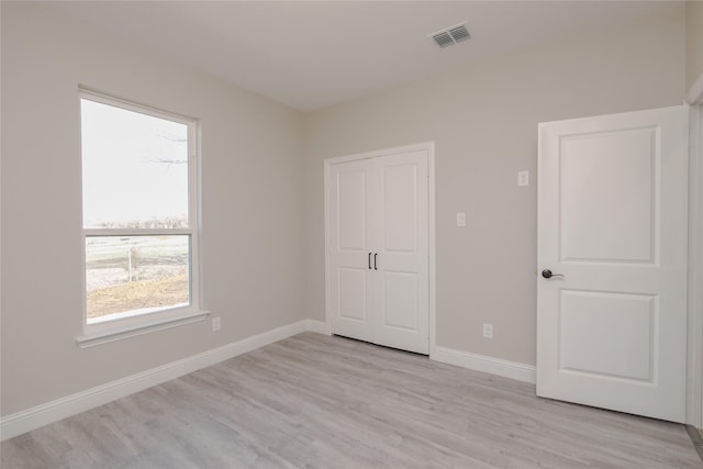 unfurnished bedroom with light wood-type flooring