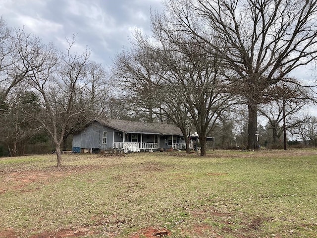exterior space with covered porch and a front yard
