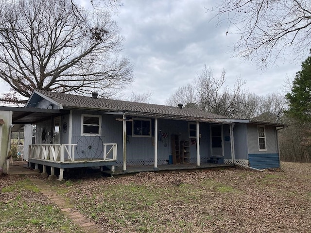 rear view of property with covered porch