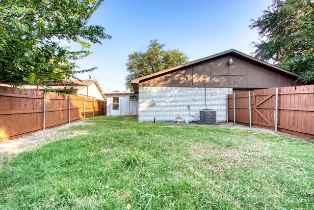 view of yard featuring a fenced backyard and central AC unit