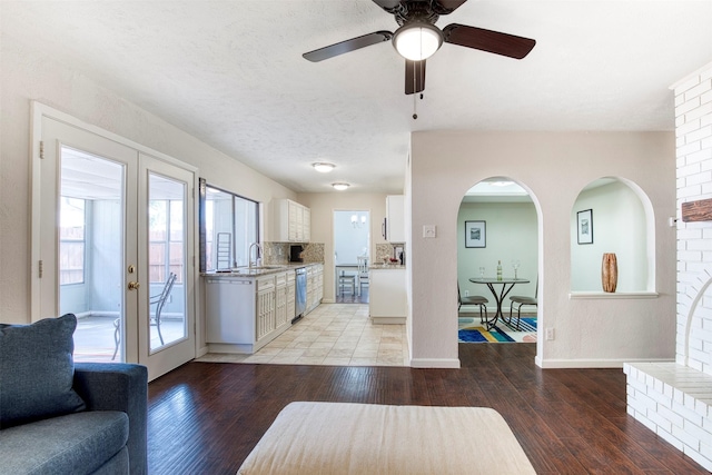 interior space featuring light wood-style floors, french doors, a sink, and a textured ceiling