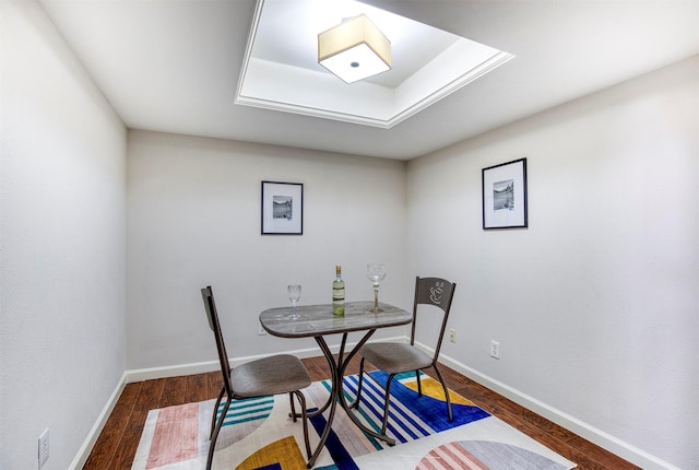 dining space featuring dark wood-style floors and baseboards