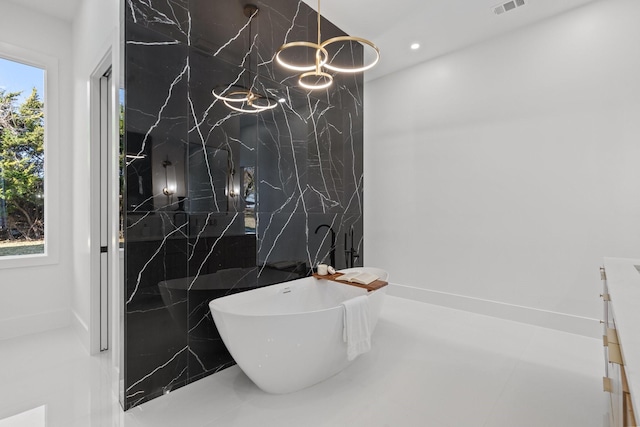 bathroom with tile walls and a bathtub