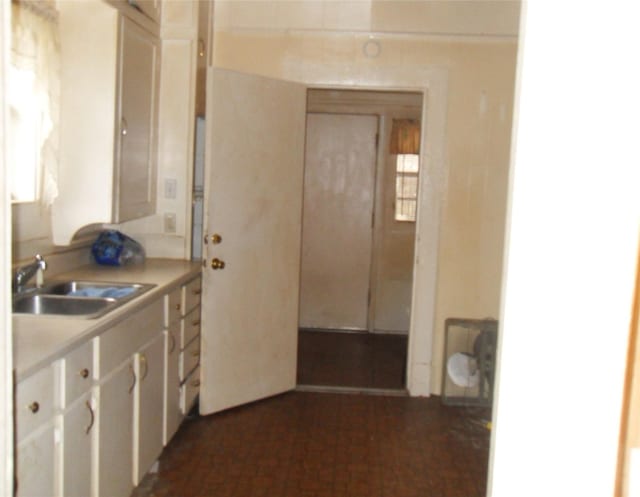 kitchen with sink and white cabinetry