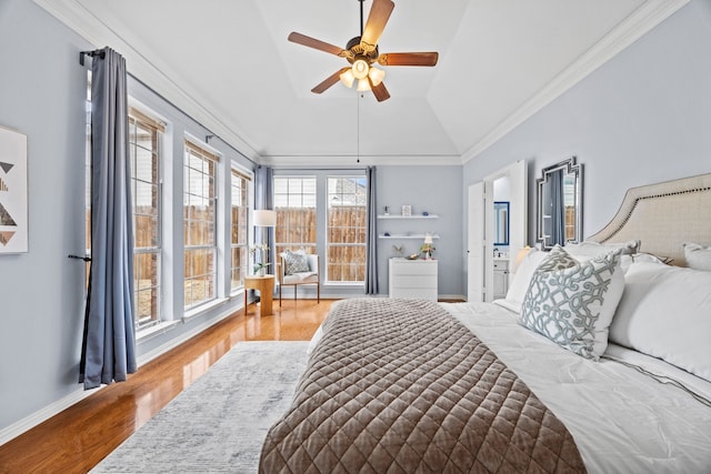 bedroom featuring ceiling fan, baseboards, vaulted ceiling, ornamental molding, and light wood-type flooring