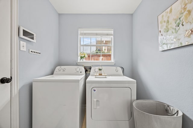 washroom featuring laundry area and washing machine and clothes dryer