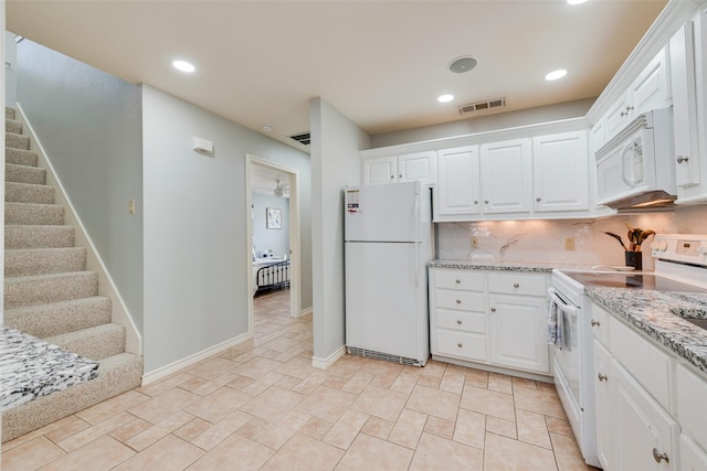 kitchen with white cabinetry, white appliances, tasteful backsplash, and light stone counters