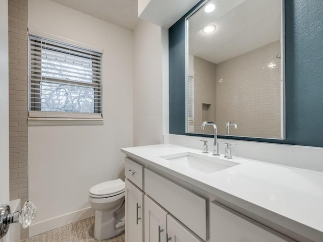 bathroom featuring tile patterned floors, toilet, and vanity