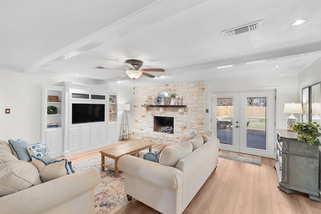 living room with light hardwood / wood-style flooring, a stone fireplace, crown molding, french doors, and beam ceiling