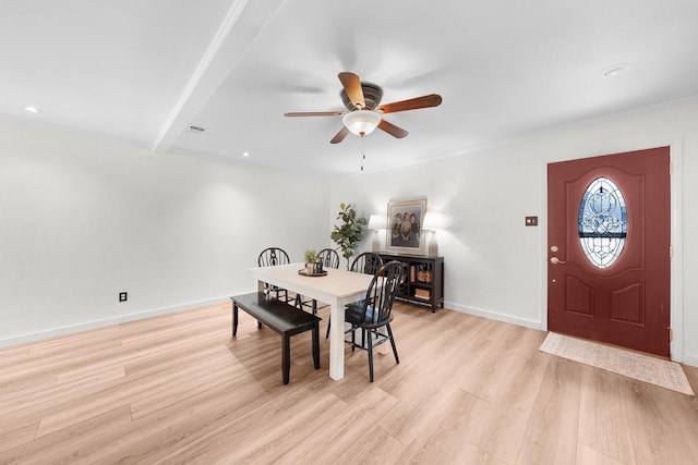 dining space with light hardwood / wood-style floors and ceiling fan