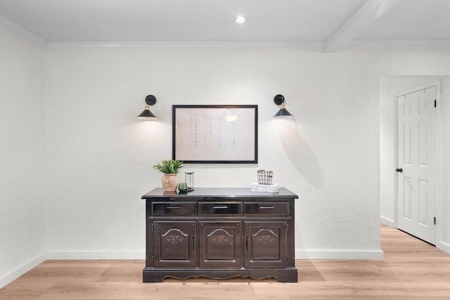 interior space featuring light wood-type flooring and ornamental molding