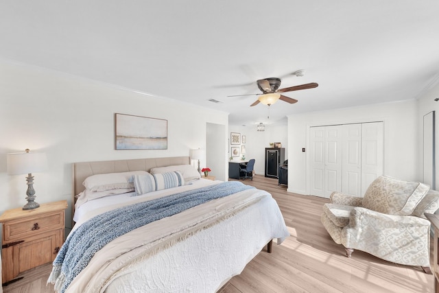 bedroom featuring ceiling fan, a closet, and light hardwood / wood-style floors