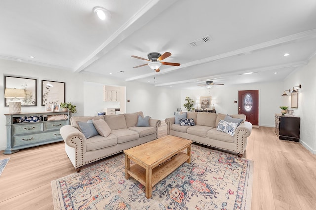 living room featuring light hardwood / wood-style floors, crown molding, and beam ceiling