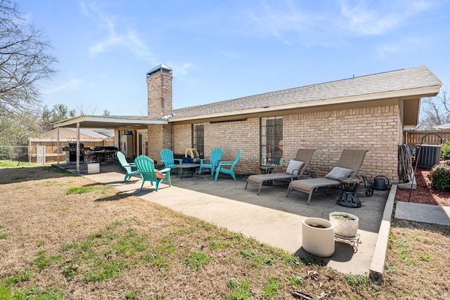 back of property featuring a patio and a lawn