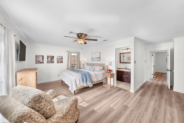 bedroom with light wood-type flooring, sink, ceiling fan, ensuite bathroom, and crown molding