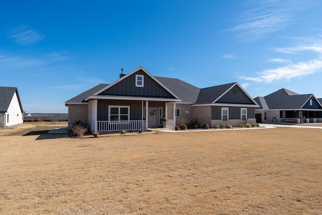 craftsman-style house featuring board and batten siding, a porch, and a shingled roof