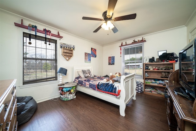 bedroom featuring dark hardwood / wood-style flooring, ornamental molding, and ceiling fan