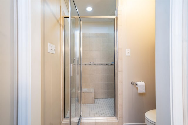 bathroom with an enclosed shower and toilet