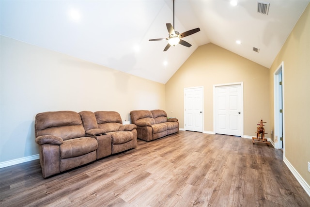 living room with hardwood / wood-style floors, high vaulted ceiling, and ceiling fan