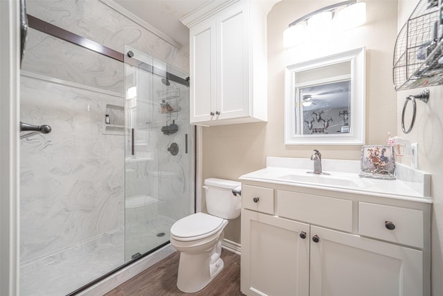 bathroom featuring hardwood / wood-style flooring, vanity, toilet, and walk in shower