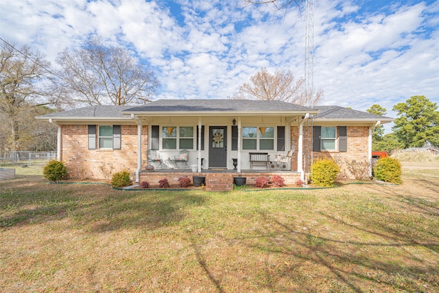 ranch-style house featuring a front yard and a porch