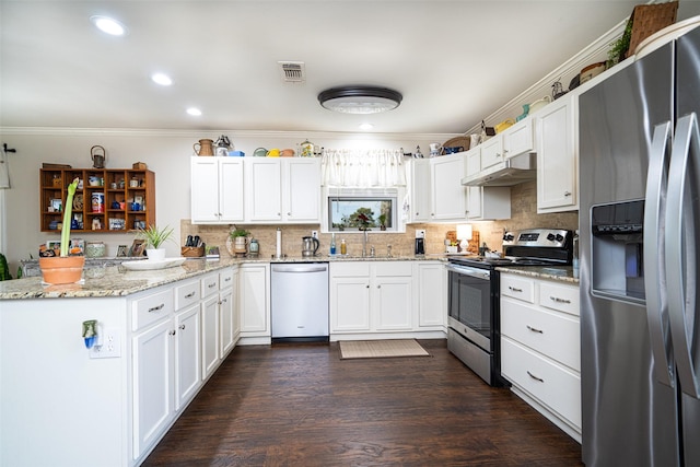 kitchen with appliances with stainless steel finishes, white cabinetry, light stone countertops, and tasteful backsplash