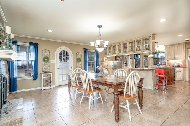 tiled dining area with an inviting chandelier and ornamental molding