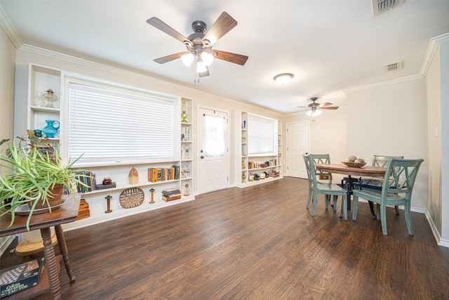 dining space featuring ceiling fan, dark wood-type flooring, crown molding, and built in shelves