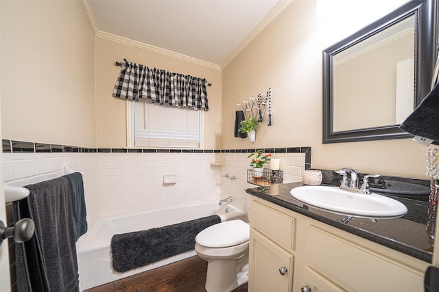 bathroom featuring toilet, tile walls, a tub, vanity, and crown molding