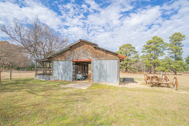 view of outbuilding featuring a yard