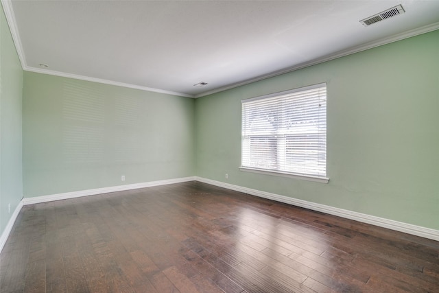 spare room with dark hardwood / wood-style flooring and ornamental molding