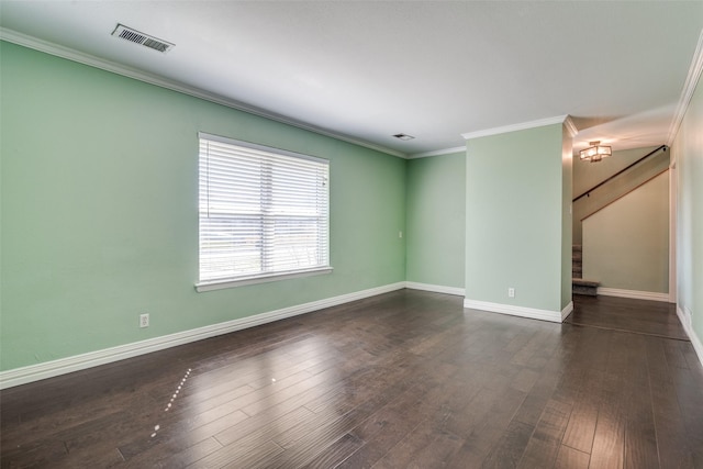 spare room with ornamental molding and dark wood-type flooring