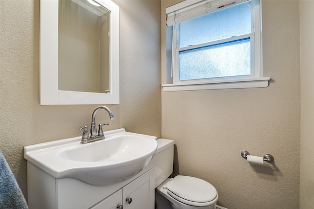 bathroom with toilet and vanity