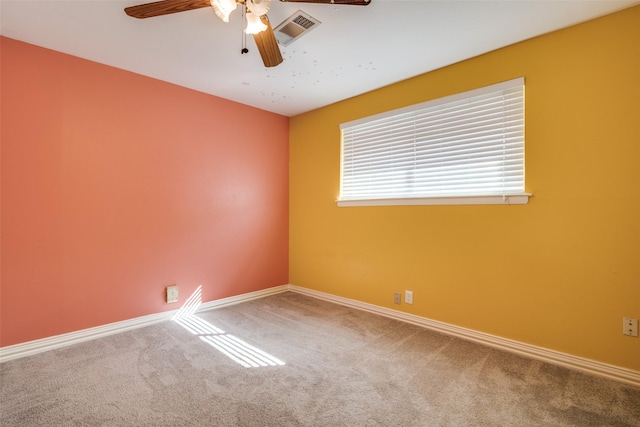 empty room featuring ceiling fan and carpet flooring