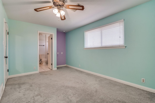 unfurnished bedroom with ensuite bathroom, ceiling fan, and light colored carpet