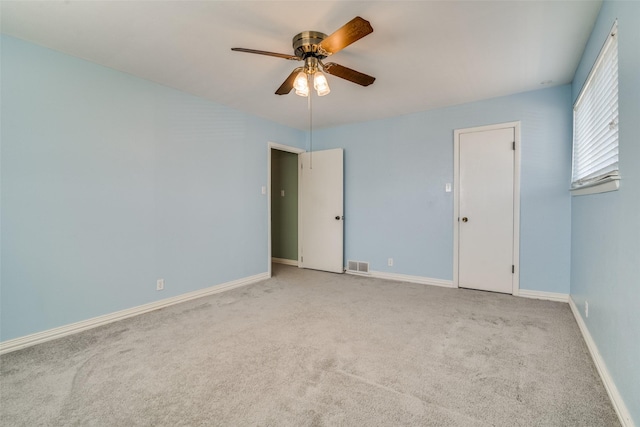 interior space featuring ceiling fan and light colored carpet