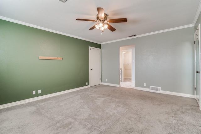 carpeted spare room featuring ceiling fan and crown molding