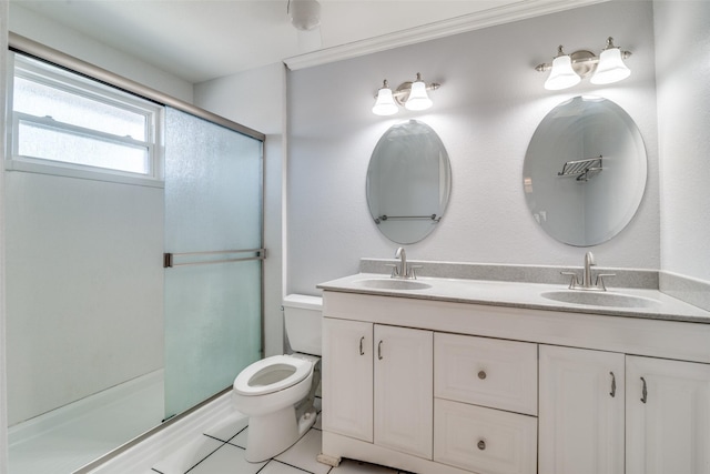 bathroom featuring toilet, vanity, and a shower with shower door