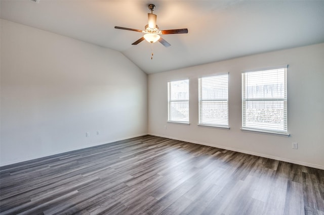 unfurnished room featuring lofted ceiling, dark wood-style floors, ceiling fan, and baseboards