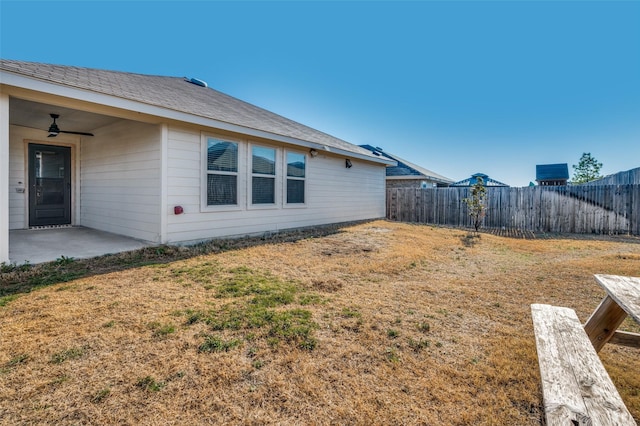 view of yard featuring ceiling fan, a patio area, and a fenced backyard