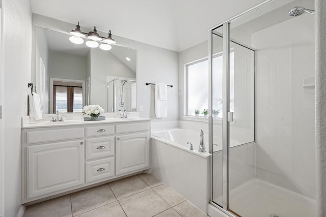 bathroom featuring tile patterned flooring, independent shower and bath, and vanity