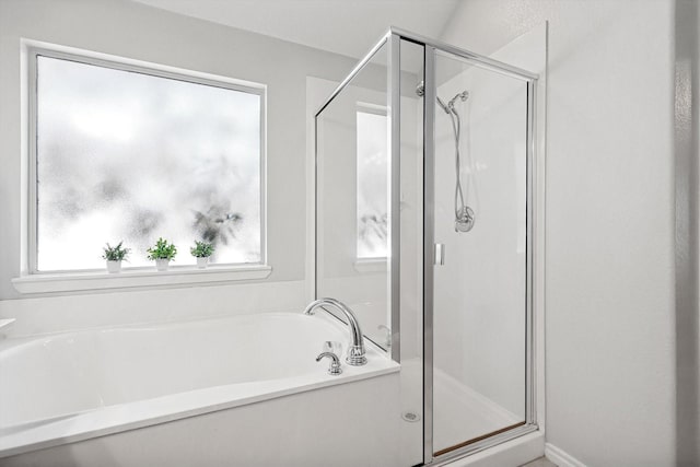 bathroom featuring independent shower and bath