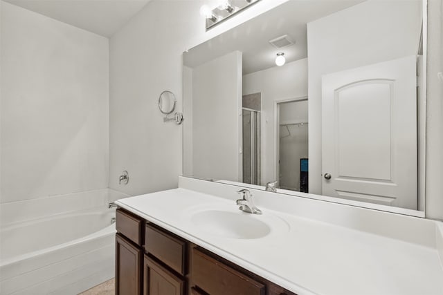 bathroom with vanity and independent shower and bath
